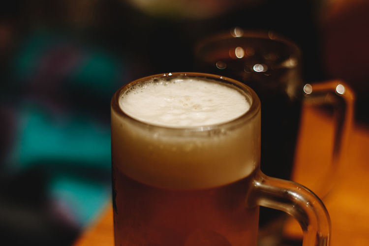 Close-up of beer on table at night