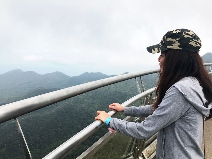 Woman standing at observation point against sky