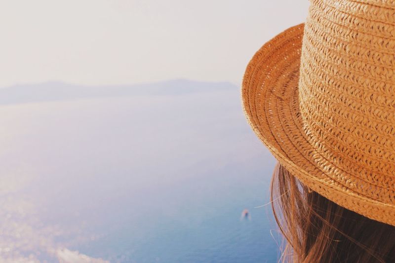 Cropped image of woman in front of sea at santorini