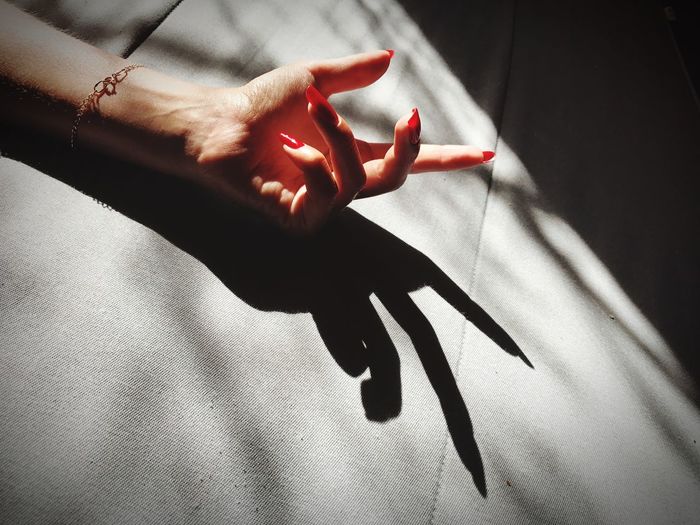 Close-up of woman hand with shadow