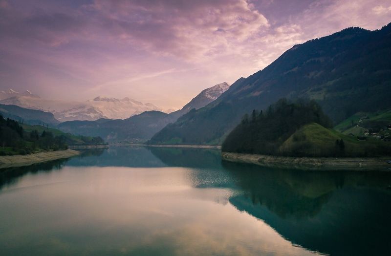 Scenic view of lake and mountains against sky
