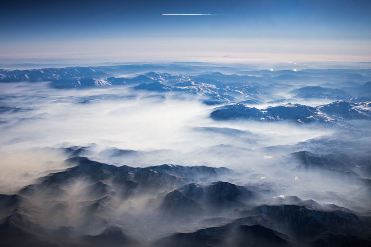 Aerial view of majestic mountains against sky