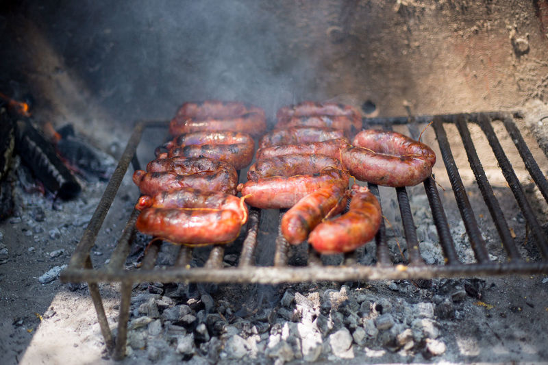 High angle view of chorizo grilling on barbecue