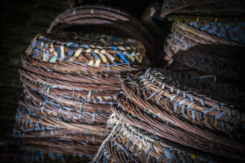Close-up of stacked wicker baskets for sale