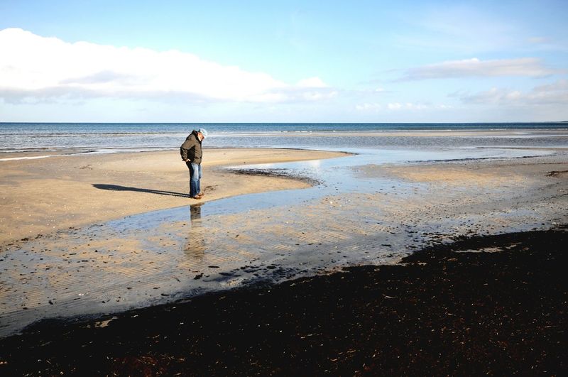 Side view of man standing on beach