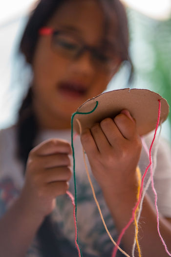 Close-up of girl making craft product