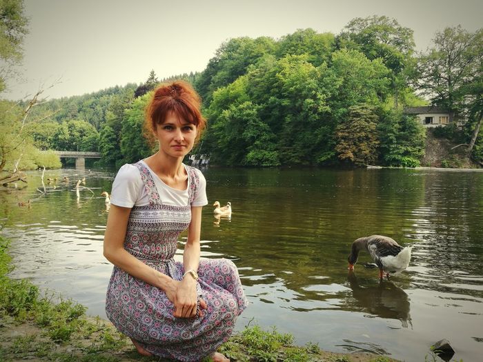 Portrait of smiling young woman in lake