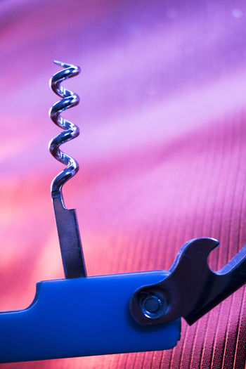 Close-up of corkscrew against illuminated background