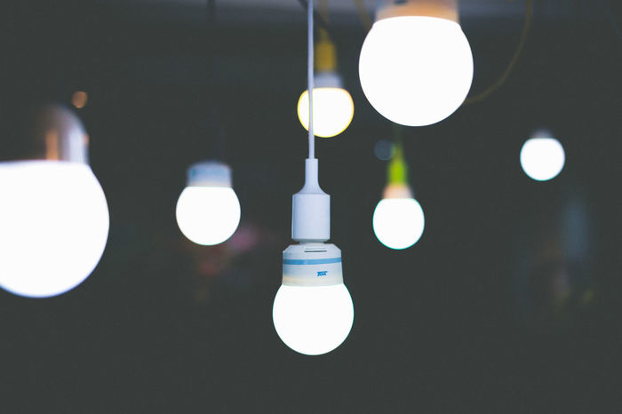 Illuminated light bulbs hanging at home
