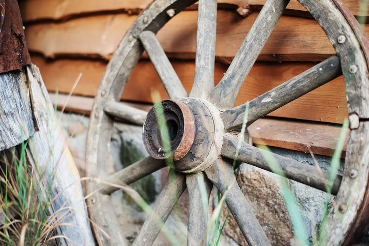 Close-up of rusty wagon wheel on wall