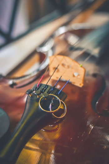 Close-up of wedding rings on violin