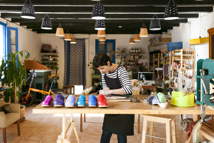 Clogmaker working in her workshop