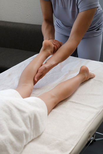 Child foot massage treatment by professional massage therapist in spa resort. wellness, stress