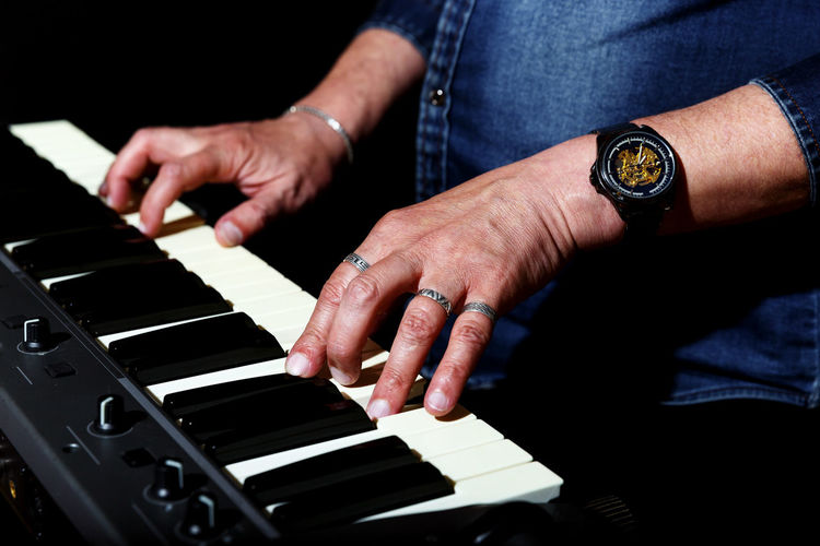Cropped image of man playing piano