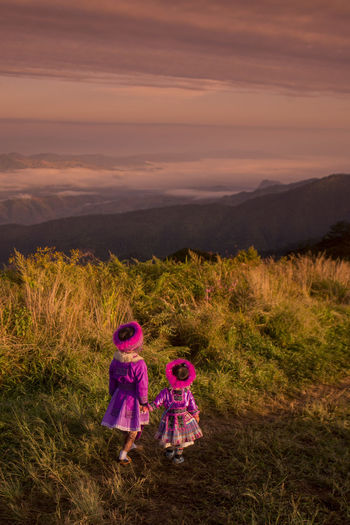 Rear view of two girls on top of the mountain