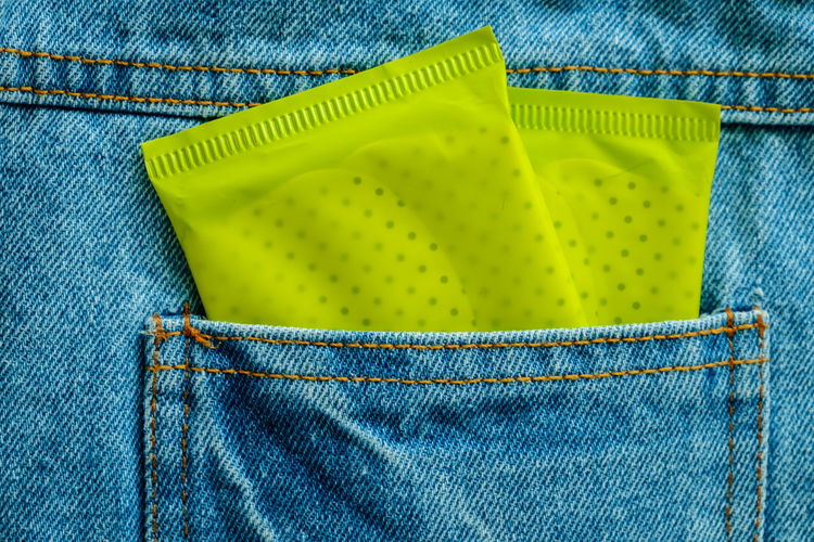 Close-up of sanitary pads in jeans pocket