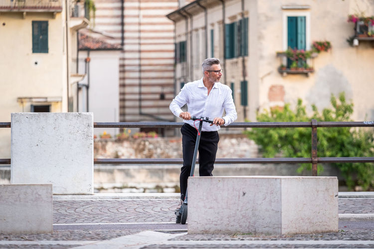 Businessman riding electric scooter