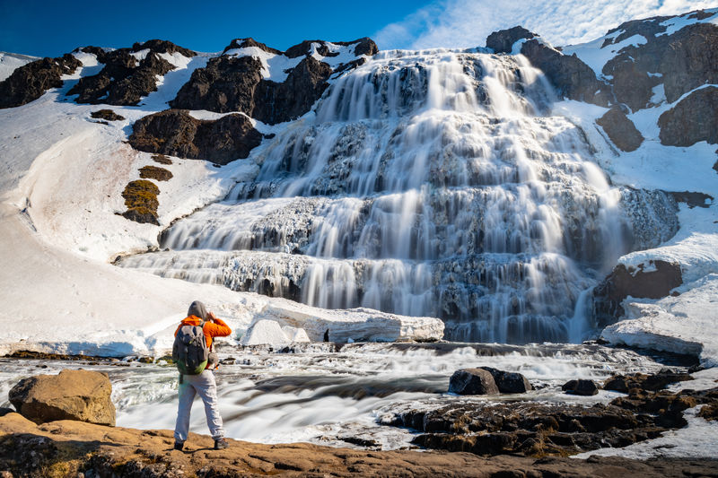 Visitor at dynjandi falls in iceland's west fjordland