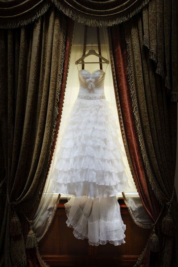 Wedding dress hanging indoors