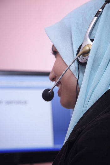 Female customer service representative using computer in office