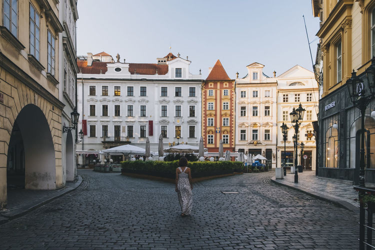 Woman walking through old town streets in prague, czech republic