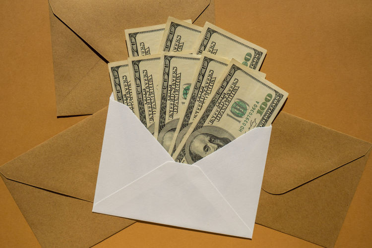 High angle view of paper with envelope on white background