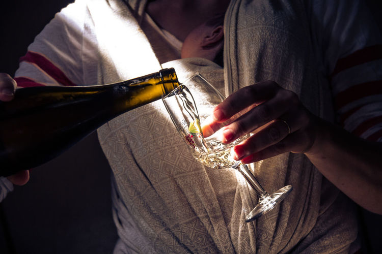 Close-up of woman pouring wine from bottle