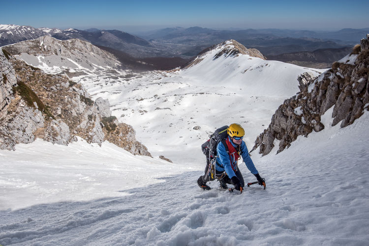 Man skiing on snowcapped mountains