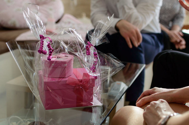 Close-up of people with gift sitting at table
