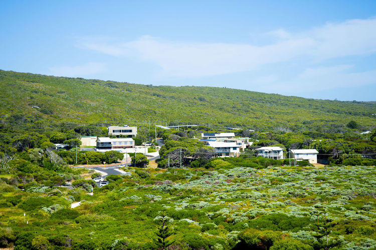 Houses in town against sky