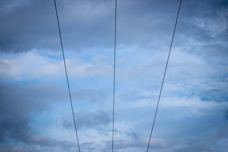 Low angle view of cables against sky