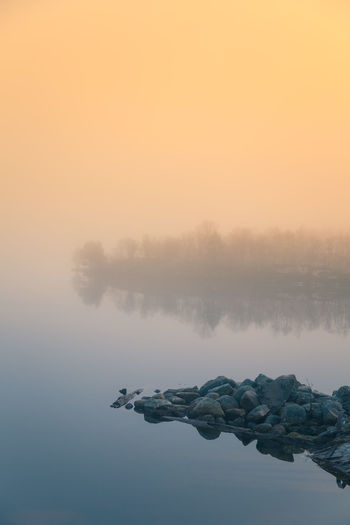 Scenic view of lake against sky during sunset