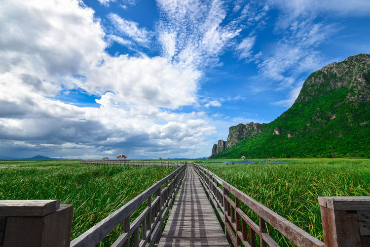 Panoramic view of empty road amidst landscape against sky