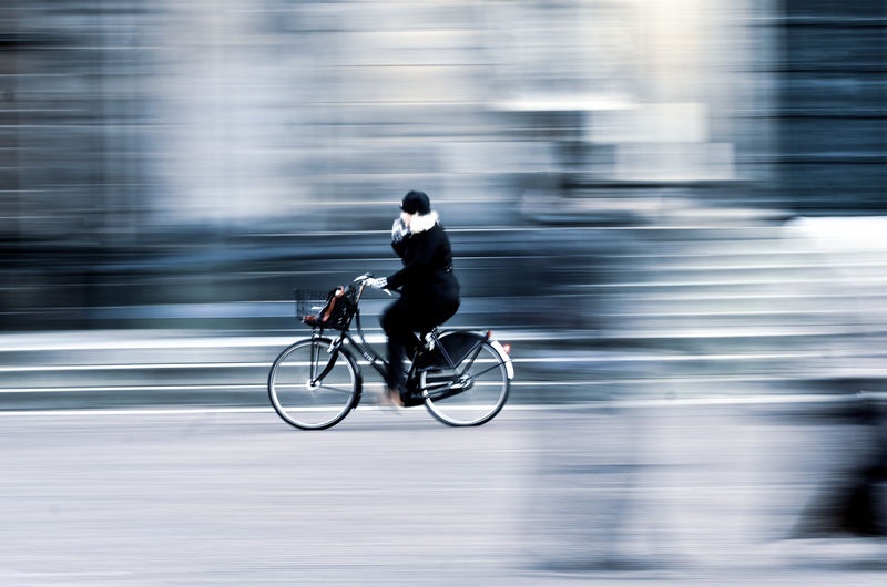 Side view of  woman riding bicycle
