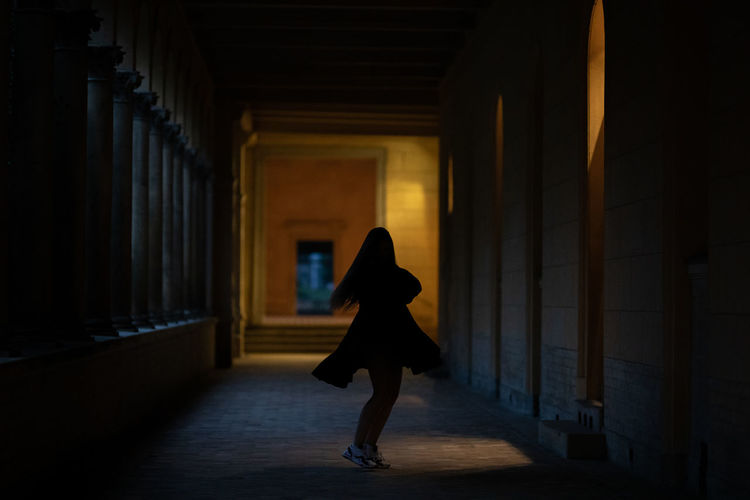 Woman walking in corridor of building