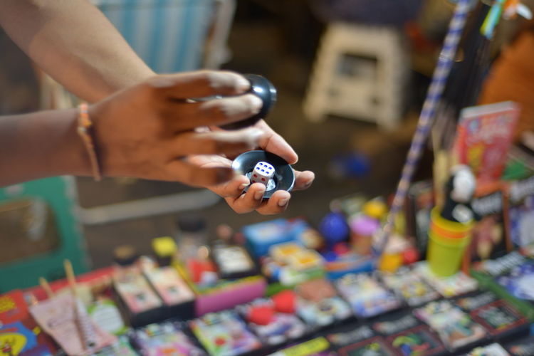 Cropped hands holding dice at market