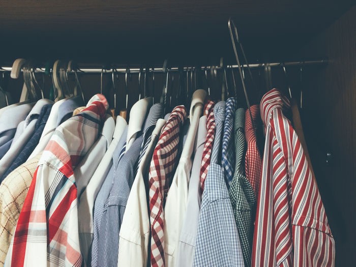 Close-up of shirts hanging in wardrobe