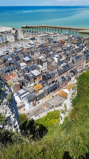 High angle view of townscape and sea in city