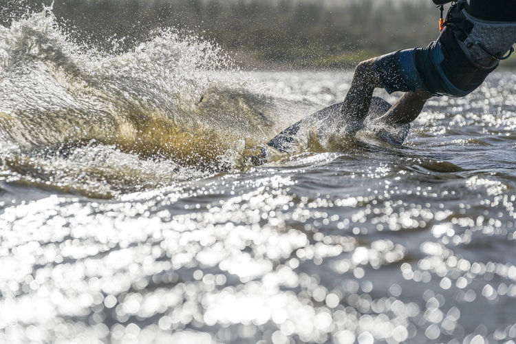 Waist-down male athlete kiteboarding in la ventana, mexico