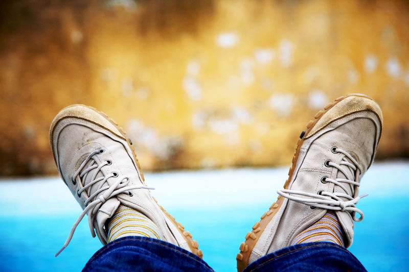 Low section of man wearing shoes