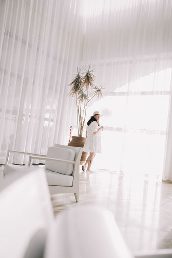 Woman in a big white lounge of a hotel 