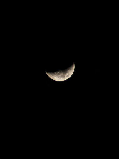 Low angle view of half moon in sky at night