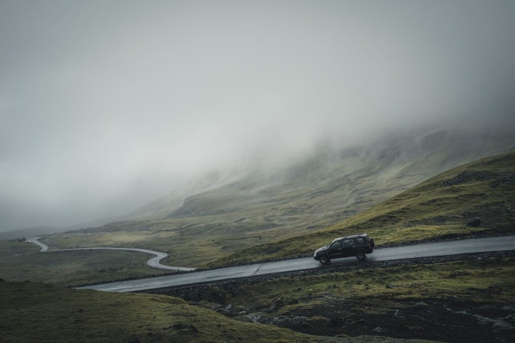 Car on mountain road at nororadalur during foggy weather