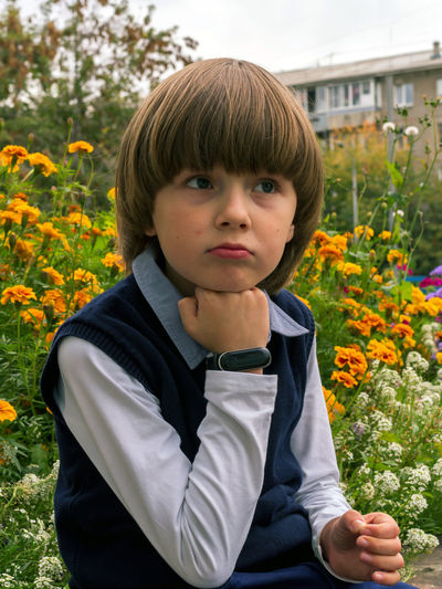 Portrait of boy on red flowering plants