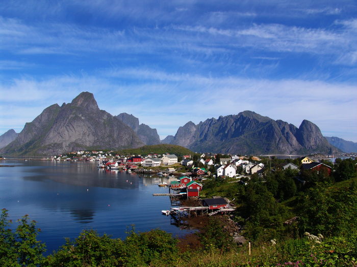 Scenic view of sea and mountains against sky