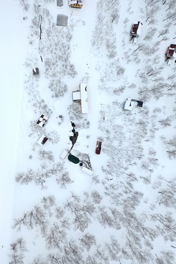 High angle view of people skiing on snow covered field