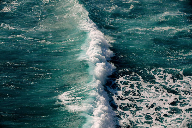 High angle view of waves rushing towards shore