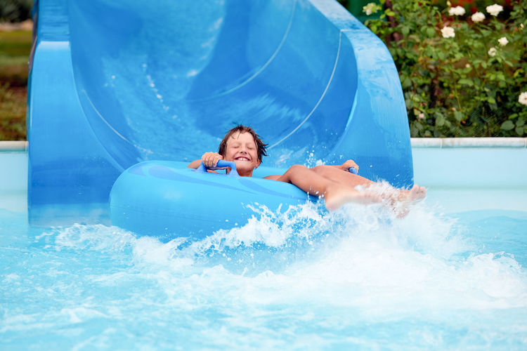 Portrait of cute boy sitting on inflatable ring
