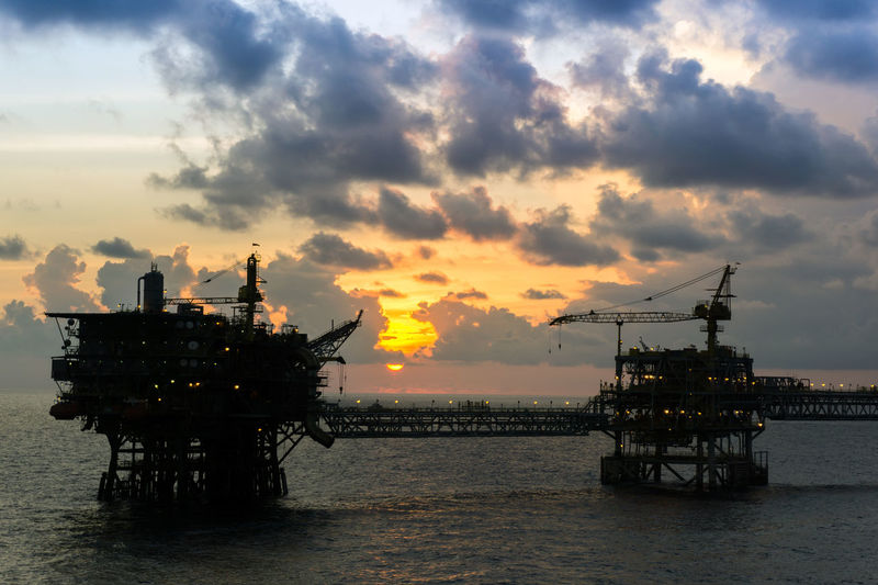 Silhouette of an oil production platform connected with bridge at offshore terengganu oil field