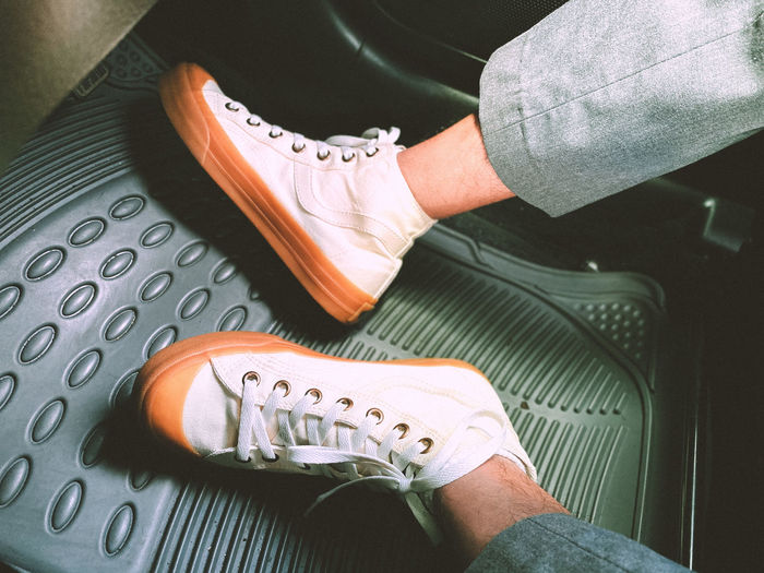 Low section of man holding shoes